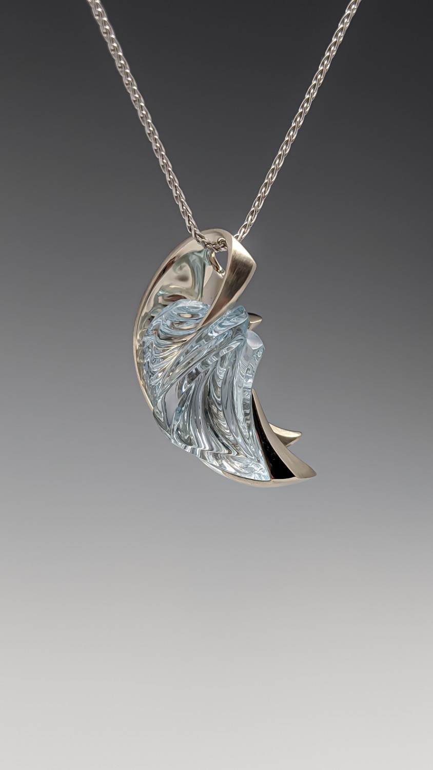 Necklaces $5,001 and Up (Two first-place winners) 57 carat carved untreated Colorado blue topaz necklace in 14K white gold Designed by: Mike Anderson Brody Designs Stevens Point, WI $16,000