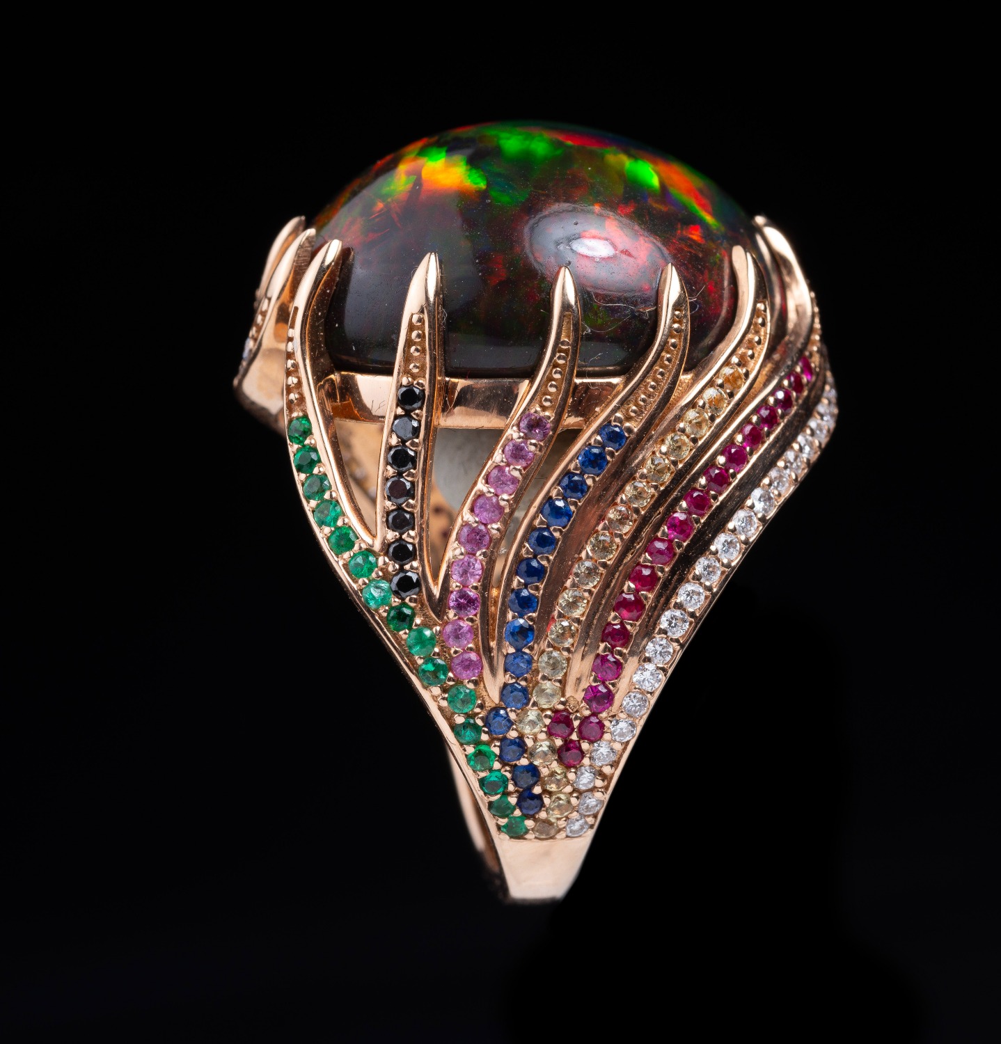 Retailer: Jewelry $10,001 to $50,000 18K rose gold ring with Ethiopian opal (16.8 ct) emeralds (.25 ctw), sapphires (0.20 ctw), rubies (.025 ctw), black diamonds (.10 ctw) and white diamonds (.25 ctw) Designed by Susan Oliver Heard Heard Gallery San Antonio, TX