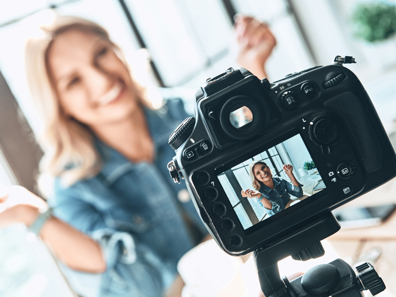 Woman posing in front of camera
