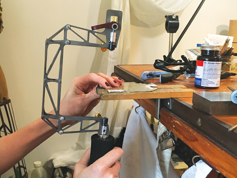 Michelle Pajak-Reynolds using a birdcage saw at her bench.