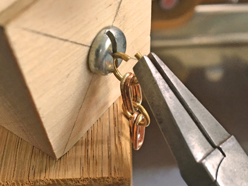 Step 6: using pliers to close the jump ring and attach it to the chain