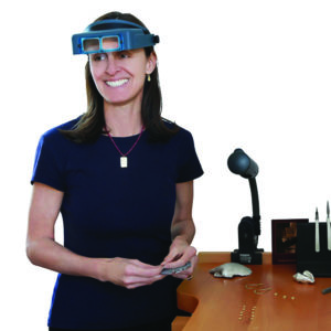 Jeweler Christina Malle standing at a jewelry bench.